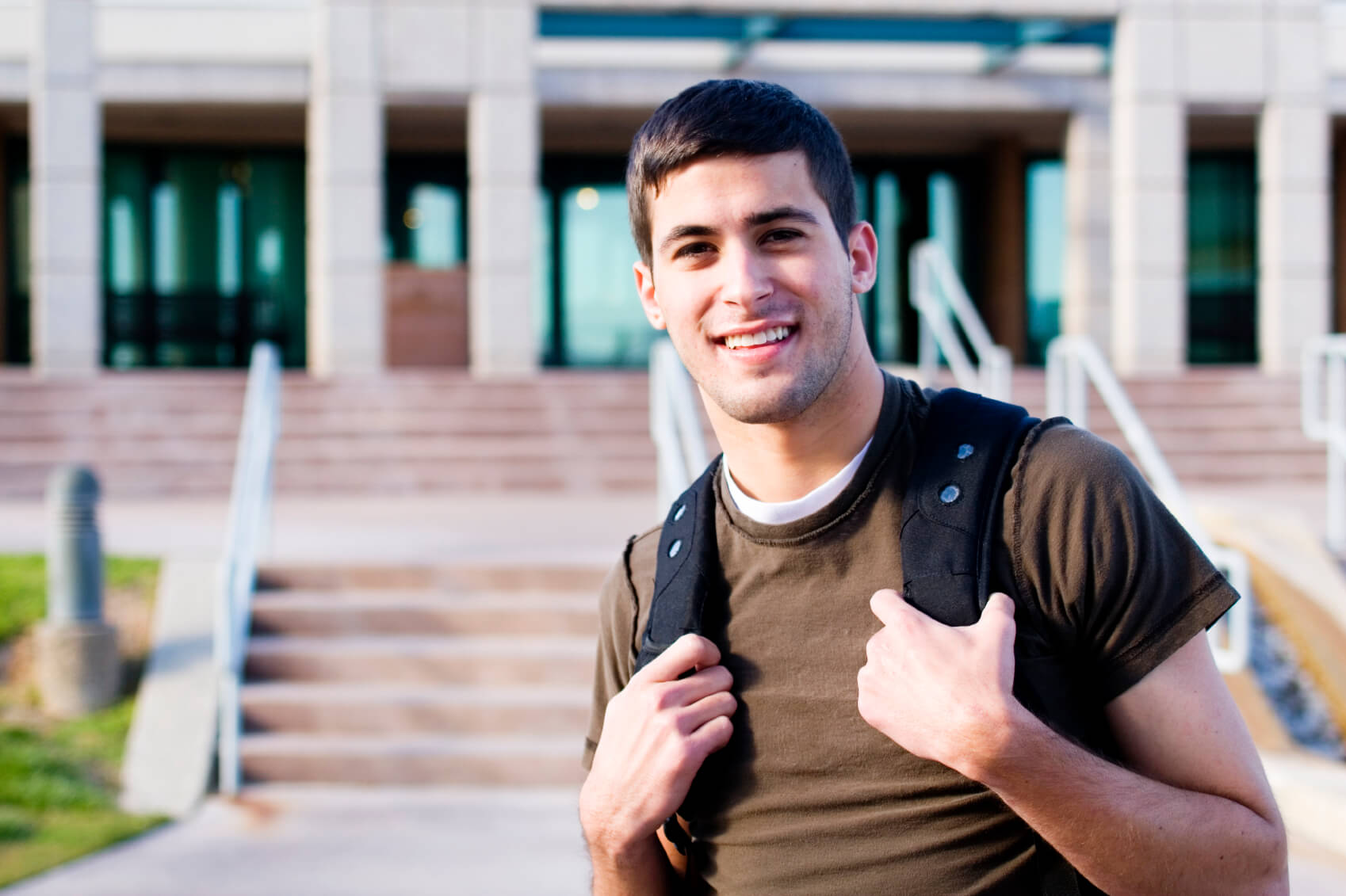 student standing outside building
